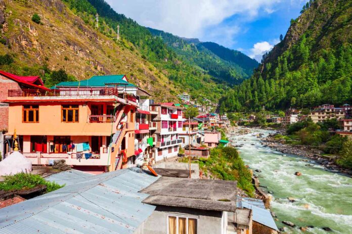 Houses near river and mountains