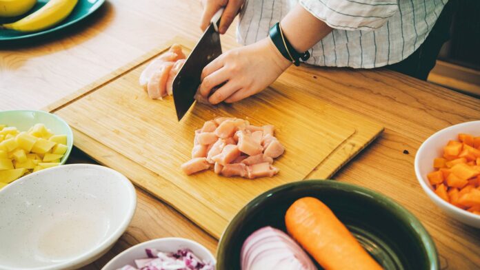 Person cutting meat